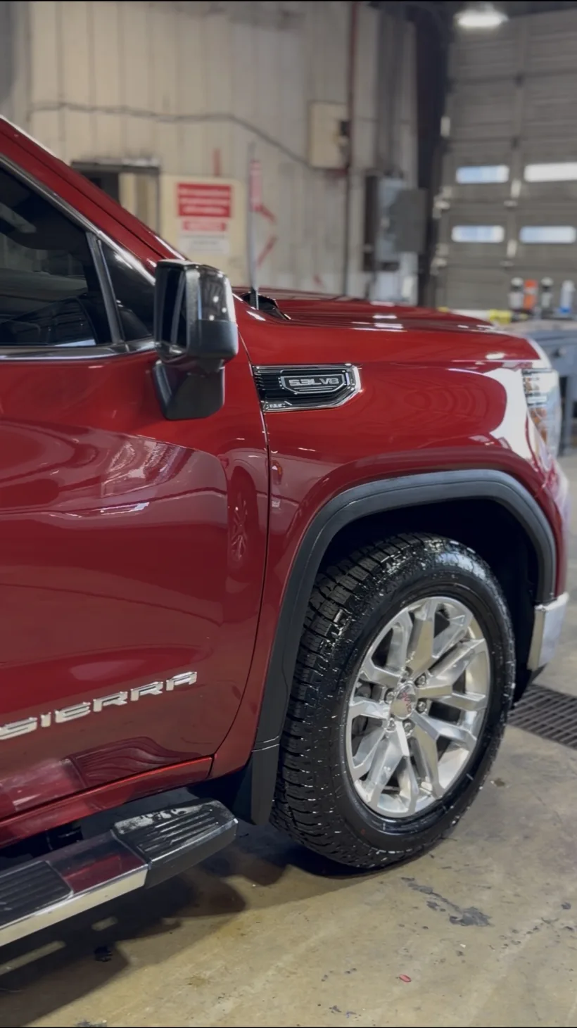 Red GMC Sierra fender and wheel after detailing