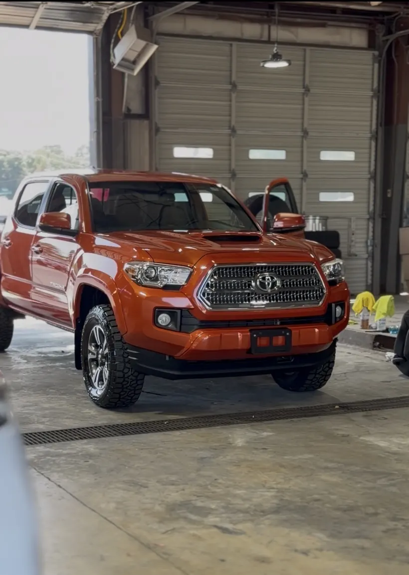 Orange Toyota Tacoma in the wash bay