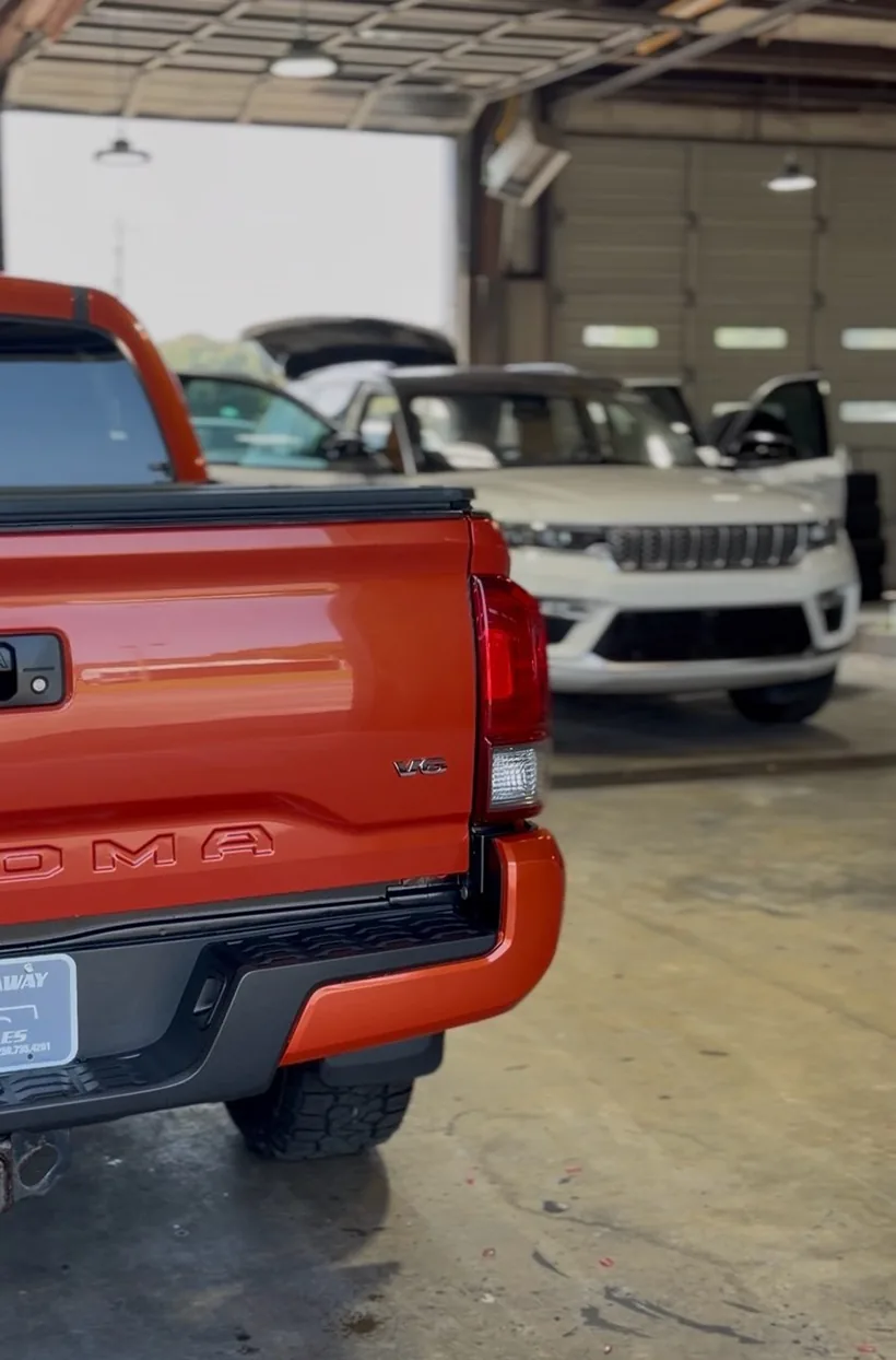 Orange GMC in the bay by Daniel’s Auto Detailing
