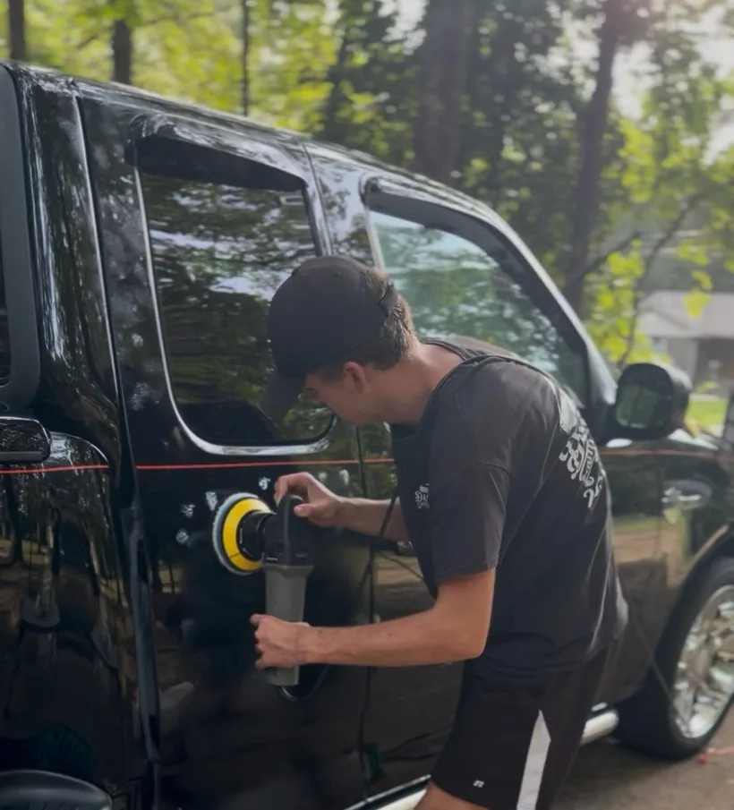 Machine polishing a black van by Daniel’s Auto Detailing